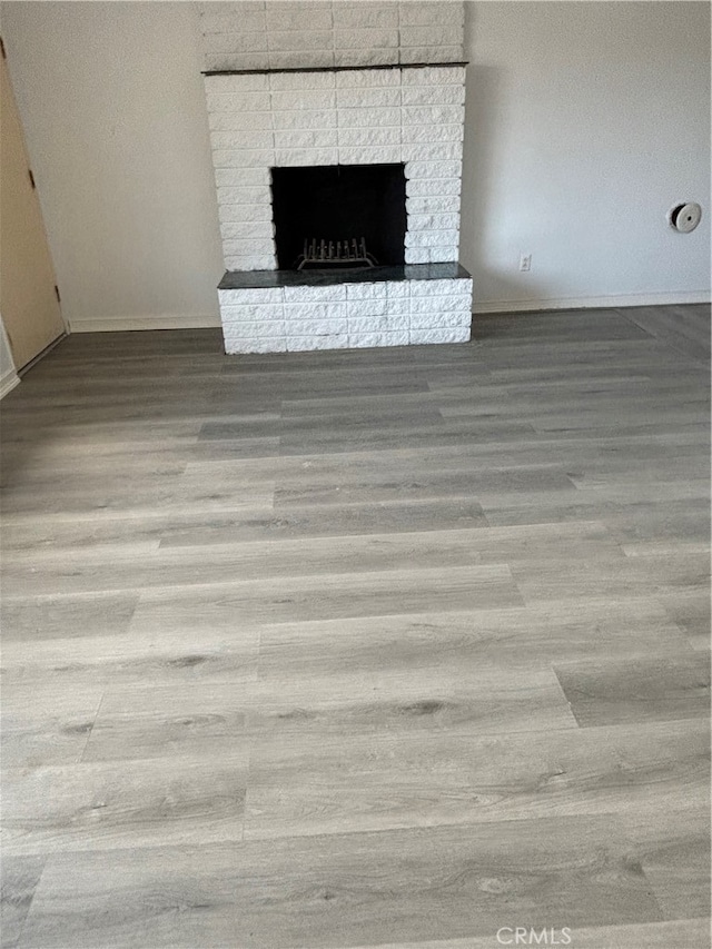 room details with hardwood / wood-style floors and a brick fireplace