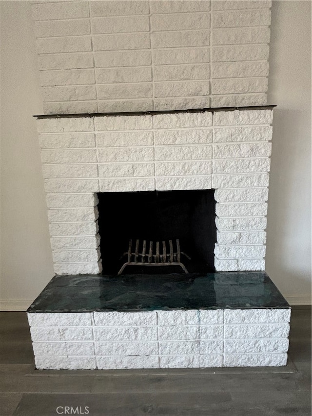 room details featuring wood-type flooring and a fireplace