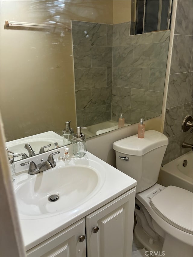 full bathroom with vanity, tiled shower / bath, and toilet