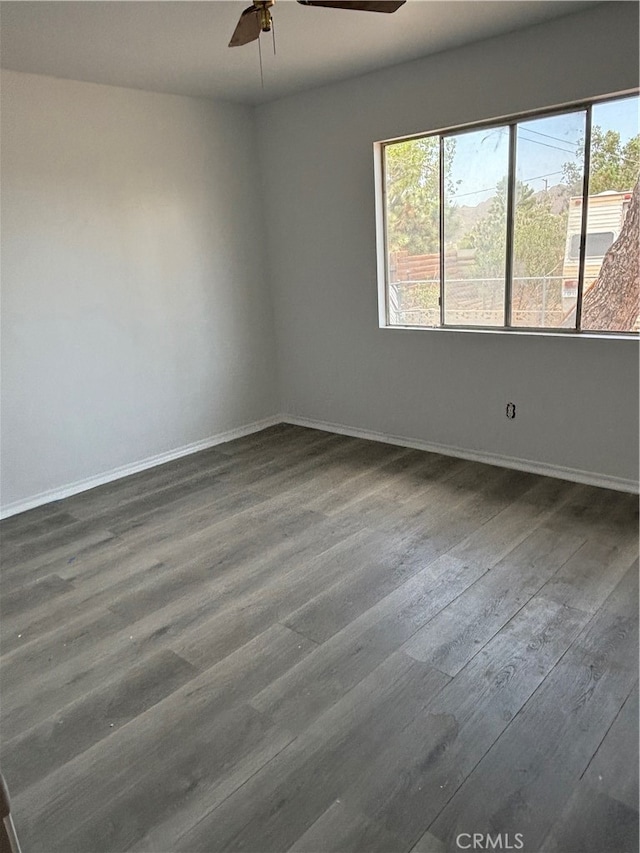 spare room featuring hardwood / wood-style floors and ceiling fan