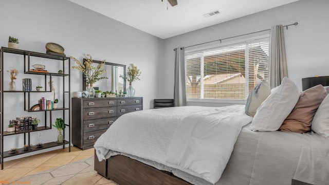 tiled bedroom with ceiling fan