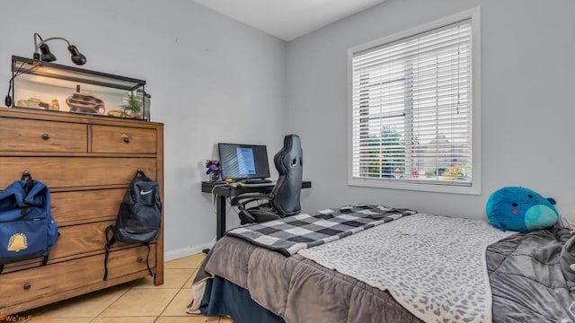 bedroom with light tile patterned floors