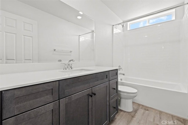 full bathroom with toilet, shower / washtub combination, wood-type flooring, and vanity