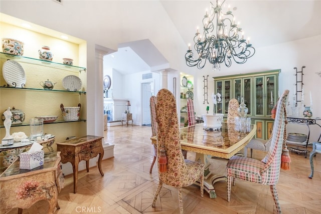 dining space with vaulted ceiling, ornate columns, an inviting chandelier, and light parquet floors