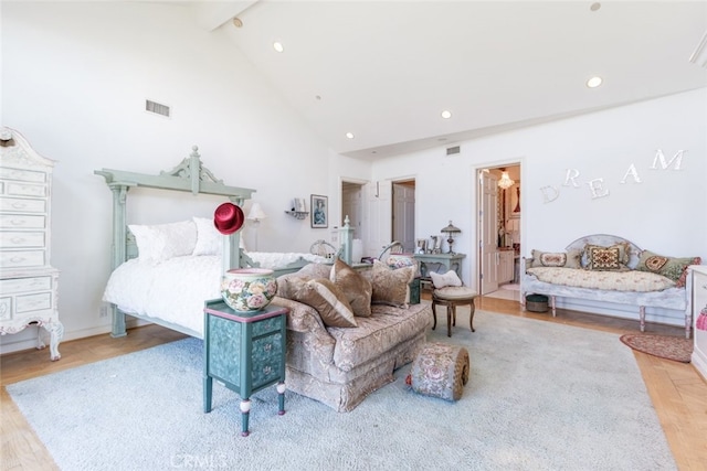 living room featuring beamed ceiling, light hardwood / wood-style flooring, and high vaulted ceiling