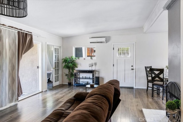 living room featuring an AC wall unit and wood-type flooring