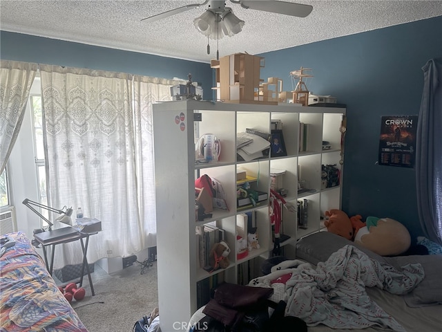 bedroom with ceiling fan, a textured ceiling, and carpet floors