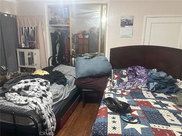 bedroom with a closet and dark hardwood / wood-style floors