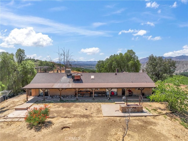 rear view of house with a mountain view