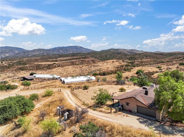 birds eye view of property featuring a mountain view and a rural view