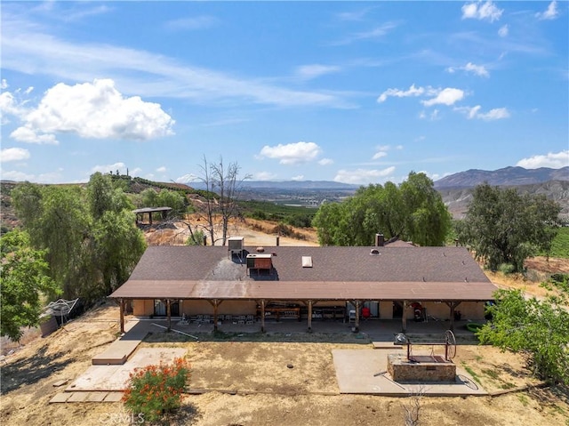 birds eye view of property with a mountain view