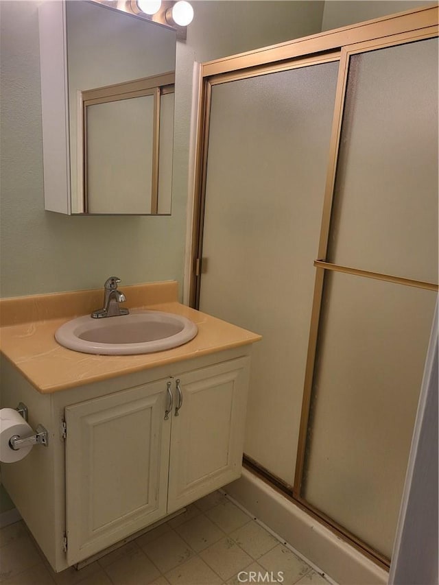 bathroom featuring walk in shower and vanity