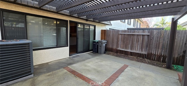 view of patio / terrace with cooling unit and a pergola