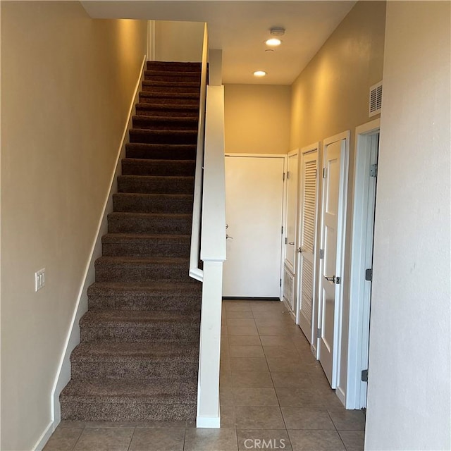 stairs featuring tile patterned flooring