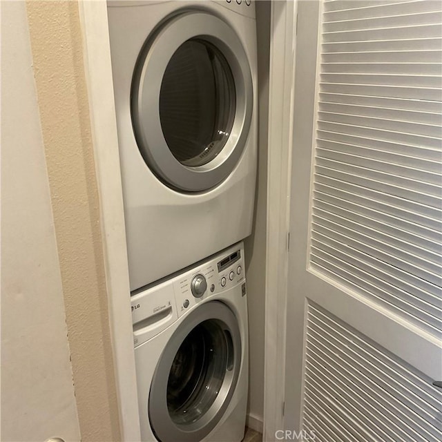 laundry area with stacked washing maching and dryer