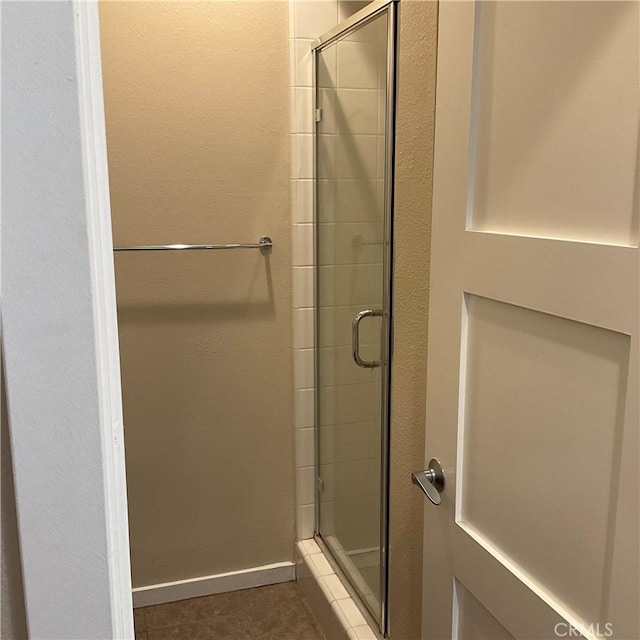 bathroom featuring tile patterned floors and an enclosed shower