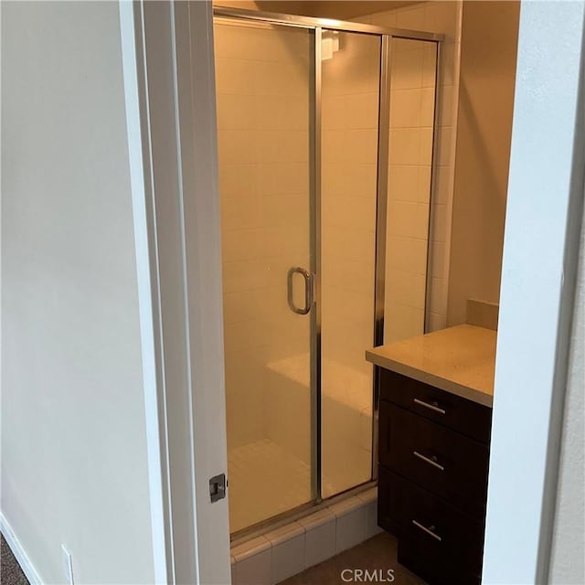 bathroom featuring a shower with shower door