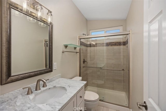 bathroom with an enclosed shower, vanity, vaulted ceiling, and toilet