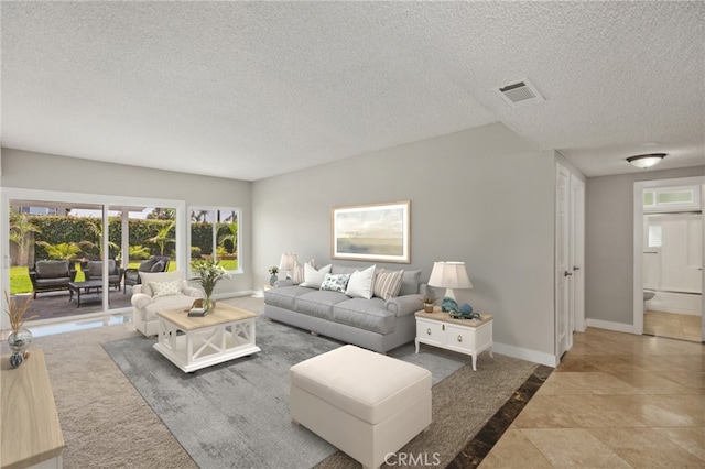 tiled living room with a textured ceiling