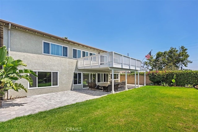 back of house with a patio area, outdoor lounge area, and a lawn