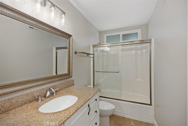 full bathroom featuring tile patterned floors, shower / bath combination with glass door, vanity, and toilet