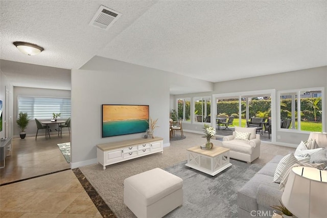 living room with tile patterned flooring and a textured ceiling