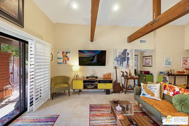 living room featuring beamed ceiling, light tile patterned floors, and a towering ceiling