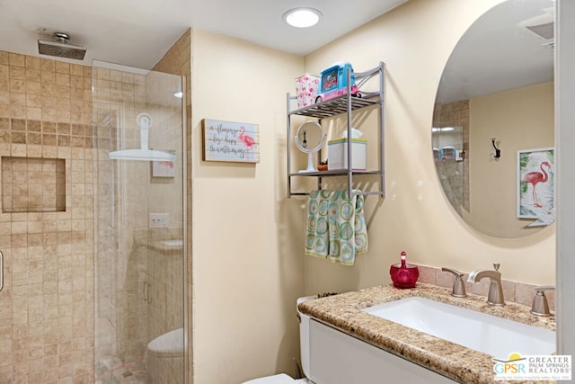 bathroom featuring toilet, vanity, and walk in shower