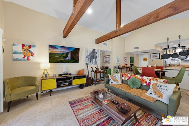 living room featuring beam ceiling, high vaulted ceiling, and light tile patterned floors