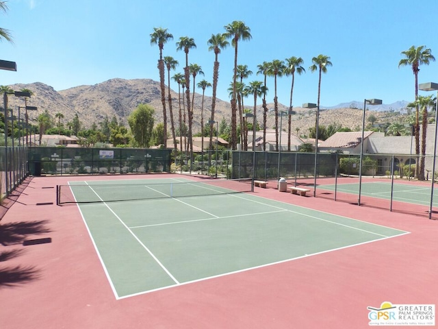 view of tennis court featuring a mountain view and basketball hoop