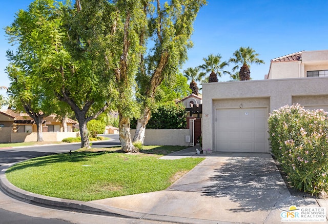 view of front facade with a garage and a front yard