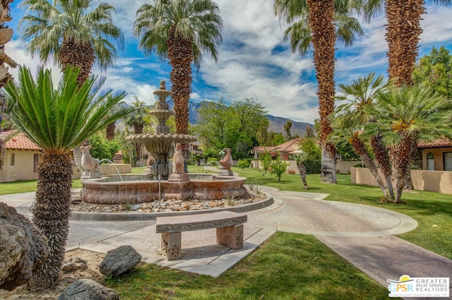 view of community featuring a lawn and a mountain view