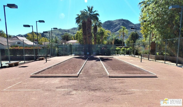 view of tennis court featuring a mountain view