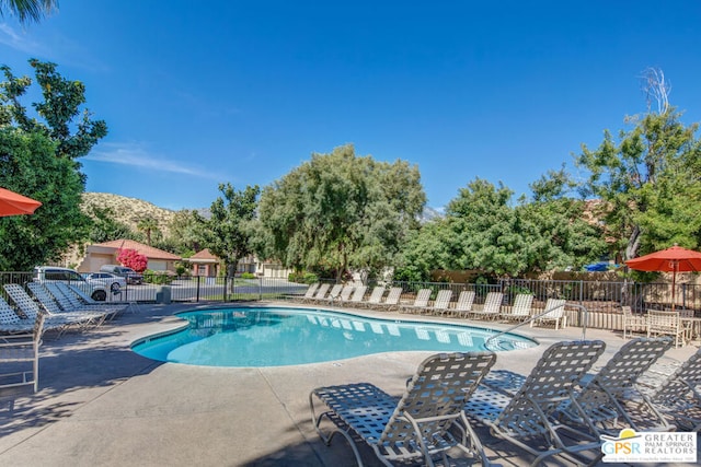 view of pool with a mountain view and a patio