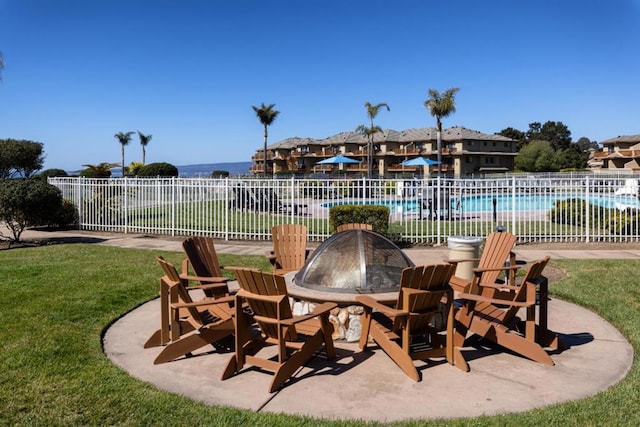 view of patio / terrace featuring a community pool and a fire pit