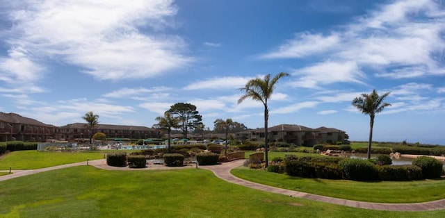 view of property's community with a lawn