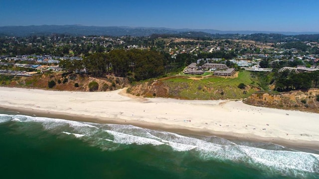 drone / aerial view with a water view and a view of the beach