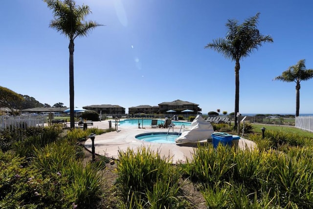 view of swimming pool featuring a community hot tub