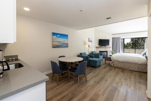 bedroom with sink and light wood-type flooring