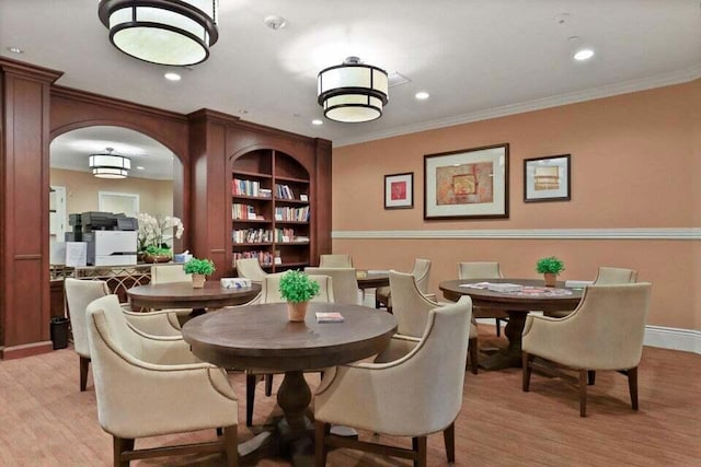 dining area featuring light hardwood / wood-style floors and ornamental molding