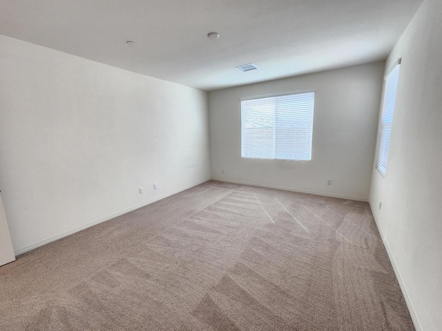 spare room with light carpet