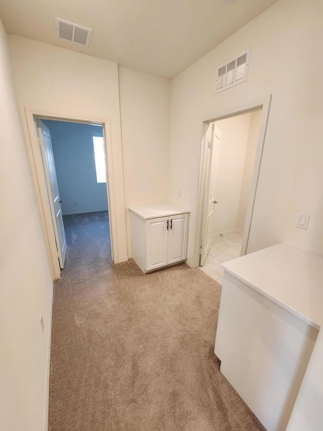 corridor with light colored carpet