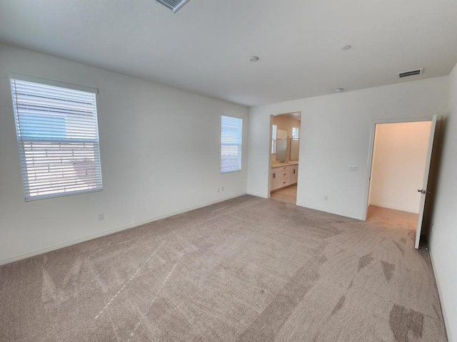 empty room with light colored carpet