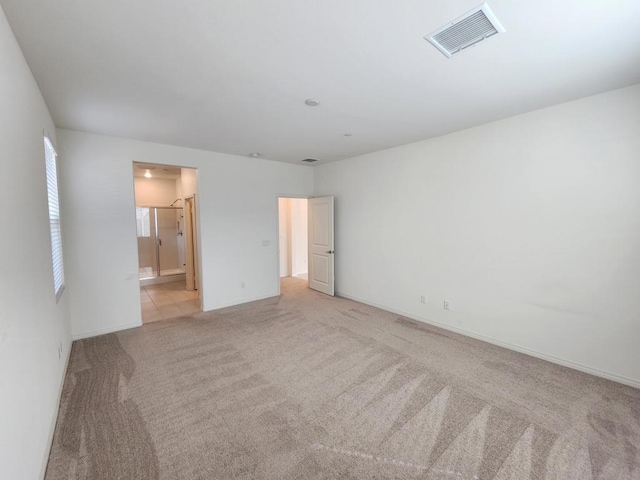 empty room featuring light colored carpet