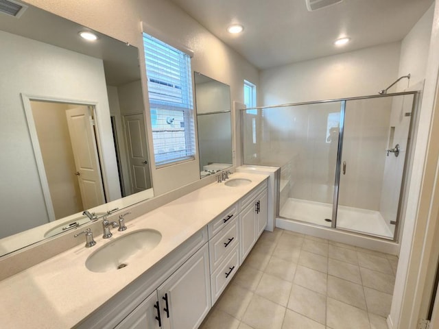 bathroom with tile patterned flooring, vanity, and a shower with door