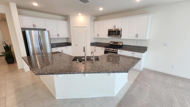 kitchen featuring white cabinets, a spacious island, sink, and appliances with stainless steel finishes