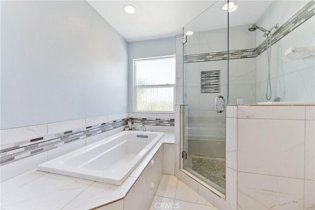 bathroom with tile patterned floors and independent shower and bath