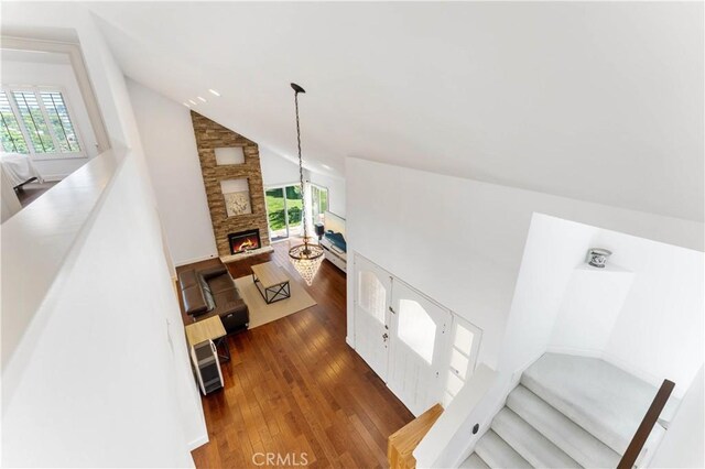 living room with high vaulted ceiling, dark hardwood / wood-style floors, and a fireplace