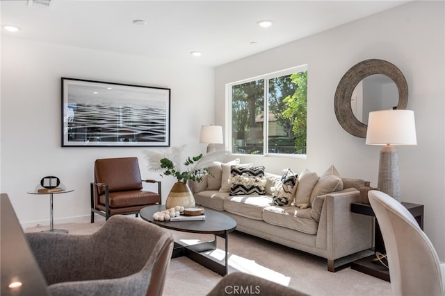 carpeted living room with visible vents, baseboards, and recessed lighting