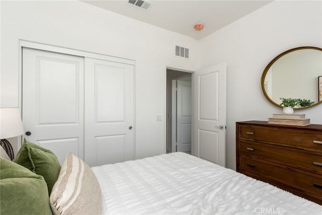 bedroom featuring visible vents and a closet